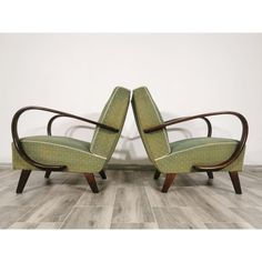 pair of mid century modern chairs in green upholstered fabric