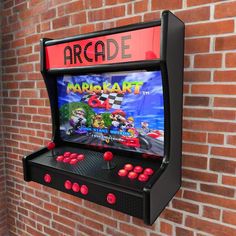 an arcade machine is mounted on a brick wall