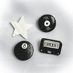 three black and white objects are arranged in the shape of a star, cassette, and an earphone