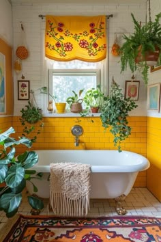 a bathroom with yellow walls and plants in the window sill above the bathtub