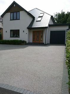 a large white house with a black garage door