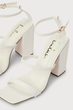 Lulus Exclusive! We just met the Lulus Mabie White Ankle Strap High Heel Sandals, and we're going crazy for how chic they are! Smooth faux leather shapes a square toe upper, a toe strap, and a vamp strap (with a bit of elastic at the side) that rises to an adjustable ankle strap with a shiny gold buckle. A trendy block heel makes these sandals easy to strut your cute self! 4. 25" wrapped block heel. Cushioned insole. Rubber sole has nonskid markings. Man made materials. Imported. Lulus | Mabie W Summer Block Heels With 4-inch Square Toe, Chic Square Toe Block Heels, Trendy Block Heels With Heel Strap And Square Toe, Chic Block Heels With Single Toe Strap For Party, Chic Square Toe Heels With Wrapped Heel, Chic Party Block Heels With Single Toe Strap, Trendy Heels With Sculpted Heel And Square Toe, Elegant Block Heels With Single Toe Strap For Party, Chic 4-inch Heeled Square Toe Shoes