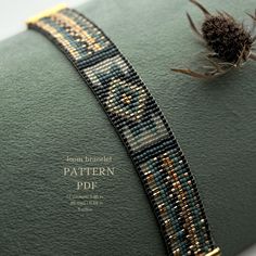 a beaded bracelet on top of a green book