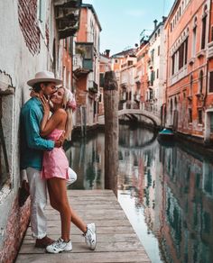 a man and woman standing on a dock in venice