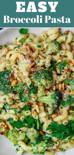 broccoli pasta with pine nuts and parsley in a white bowl