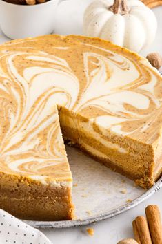 a pumpkin cheesecake with a slice missing from it