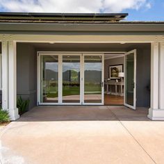 an open patio with sliding glass doors leading into the back yard