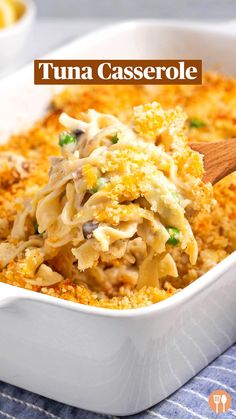 a casserole dish filled with pasta and chicken in a white baking dish on a blue table cloth