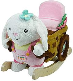 a white stuffed animal with a pink hat on it's head sitting in a toy wagon