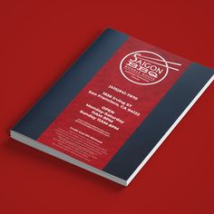 a red and black book on a red surface