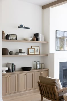 a living room filled with furniture and a fire place in the middle of it's wall