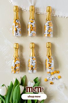 wedding favors are displayed on a table with tulips