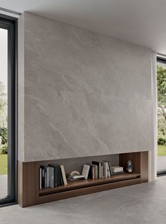 a book shelf with books on it in front of a large glass door that leads to the outside