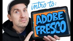 a man holding up an ipad with the words adobe fresco on it in front of him