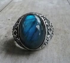 solid large labradorite ring mans wedding or dress ring beautiful scroll antique effect. solid sterling silver (925) Solid not hollowed out in the back stone flashes blues and grey with black flecks..few inclusions. Avaliable in many stones Stone measures 17 mm x13mm (6/8 ''x 4/8'' approx.) The stone will be set once sold.1 This ring I can make any size. It weights 12.2 gms approx It is 21mm (7/8 '' wide) It tapers to 3.5mmat the back If a different size is required pls convo me Elegant Metal Jewelry With Stone Setting, Sterling Silver Open Ring Jewelry Engraved, Heirloom Style Adjustable Sterling Silver Jewelry, Spiritual Oval Stone Setting Jewelry, Handmade Silver Labradorite Jewelry, Engraved Sterling Silver Open Ring, Spiritual Style Open Promise Ring, Spiritual Open Promise Ring, Engraved Heirloom Metal Jewelry