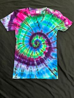 Each of my Tie Dye products is had made by myself a small batch artist based in Colorado. All shirts start with a cotton shirt used for its great comfort over time and its ability to hold color. The use of Fabric reactive dye provides years of bright colors. Each shirt is a unique item and there are no two alike.  This super soft 100% Cotton V-Neck has colors that pop. Tied and dyed in a classic spiral design. Rich deep shades of blue and purple make this a real classic. Spiral Design, Tie And Dye, Small Batch, Shades Of Blue, Cotton Shirt, Neck Tie, Favorite Outfit, Blue And Purple, Colorado