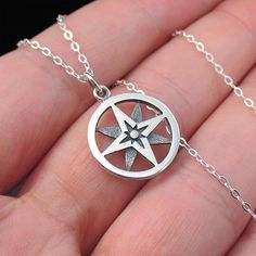 This necklace features a round openwork sterling silver north star compass charm on a delicate sterling silver chain. The compass has long been considered a good luck charm and a symbol of protection and guidance while the North Star represents inspiration, hope, and limitless possibilities. Pendant Diameter 15 mm Chain Type Cable Chain Width 1.3mm Clasp Type Spring Ring Chain Length 16,18,20" Metal Sterling Silver Color Sterling Silver Metal Purity 925 Production Time 2-3 Business Days Sterling Silver Star Charm Necklace, Sterling Silver Medallion Jewelry With Star Charm, Sterling Silver Star-shaped Jewelry With Compass Design, Symbolic Sterling Silver Jewelry With Compass Design, Symbolic Sterling Silver Necklace With Compass Design, Silver Medallion Charm Necklace With Compass Design, Silver Star-shaped Necklace With Compass Design, Symbol Of Protection, The North Star