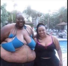 two women standing next to each other in front of a swimming pool