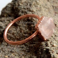 Raw Rose Quartz Ring, Natural Rose Quartz Ring, Dainty Rose Quartz Electroplated Ring,  Boho Handmade Copper Jewelry, Handmade Ring For Gift  Note : Due to the natural formation of this gemstone. Slight variation in design and color are  to be expected. Ring Size: All Sizes Available Gemstone : Rose Quartz Material: Copper Polish: Rose Gold, Gold, Silver, Copper, Black,  Contact us for wholesale prices. Raw Rose Quartz Ring, Gold Thumb Rings, Tiny Diamond Ring, Handmade Copper Jewelry, Gold Toe Rings, Rough Rose Quartz, Gold Pinky Ring, Dainty Rose, Mountain Jewelry