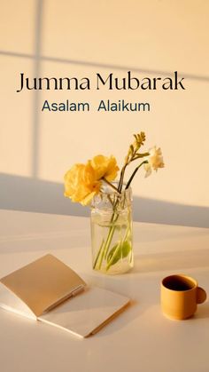 a vase filled with yellow flowers sitting on top of a table next to a book