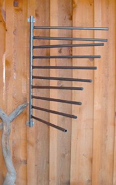 a wooden wall with several metal rods on it