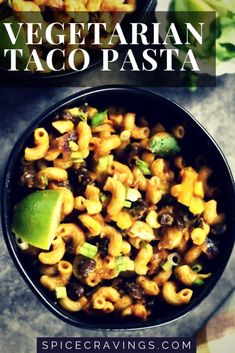 a black bowl filled with pasta and vegetables