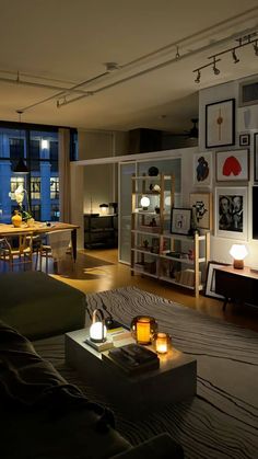 a living room filled with furniture and candles