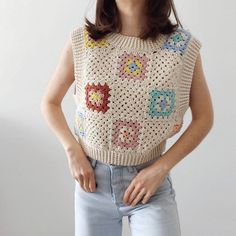 a woman wearing a crochet top with flowers on it