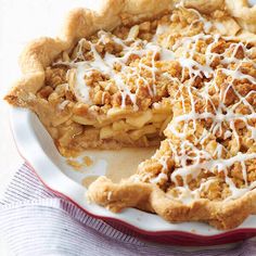 a pie with white icing on top sitting on a plate