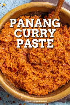 panang curry paste in a brown bowl with a wooden spoon and text overlay reading panang curry paste