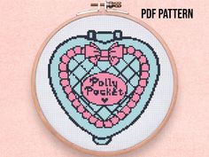 a cross stitch heart with the words dolly rock on it in pink and blue colors