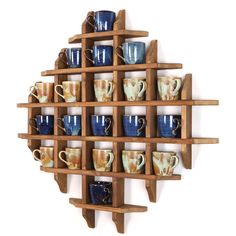 a wooden shelf filled with lots of coffee mugs on top of eachother