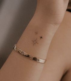 a woman's arm with a star tattoo on it