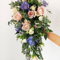 a person holding a bouquet of flowers in their hand