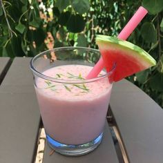 a watermelon drink with two straws sticking out of it