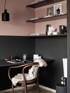 a chair and desk in a room with black walls