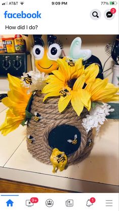 a basket with sunflowers and bees in it sitting on a counter next to other items