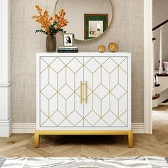 a white and gold cabinet in a living room with a mirror on the wall above it