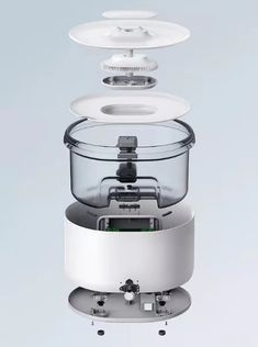 an image of a food processor with three lids on it's sides and one lid open