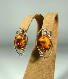 Valentines Day Perfect Gift!Elevate your style with our Handmade Earrings featuring spectacular orange amber set in textured 925 sterling silver. These exquisite earrings are designed for women who appreciate unique and original jewelry. The vibrant orange amber stones are beautifully complemented by the textured silver, creating a stunning and eye-catching piece that adds a touch of elegance and sophistication to any outfit. Product Details: Material: 925 Sterling Silver Stone: Orange Design: T Orange Design, Amber Earrings, Amber Stone, Wedding Jewelry Earrings, Original Jewelry, Amber Jewelry, Vibrant Orange, Elegant Gift, Wedding Earrings