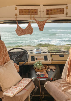 the interior of an rv with two beds and chairs