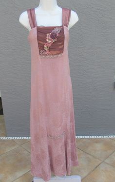 "Beyond pretty, all the way to dreamy, this sleeveless dress is a luscious mix of rayon and silk pastel pink fabric. In a typical Alexis Spencer design this vintage longer length dress features lavender and mauve details at the bodice and in the lavender lace ribbon type accents on the skirt. Boho Chic style, this dress is exquisite and beautifully wearable for day or evening events. There is a size label showing size 10 Petite, however please use the measurements to determine if it will fit you Fitted Sleeveless Mauve Maxi Dress, Pastel Pink Fabric, Ash Pink, Alexis Dress, Long Length Dresses, Lace Ribbon, Paper Tags, Size Label, Pink Fabric