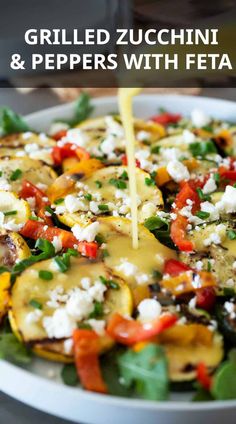 grilled zucchini and peppers with feta being drizzled over