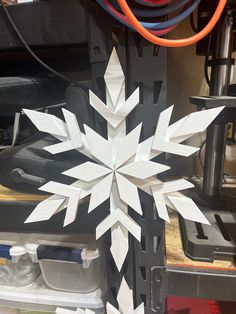 a white snowflake sitting on top of a table next to a machine tool