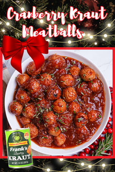 a white plate topped with meatballs covered in gravy next to a christmas tree