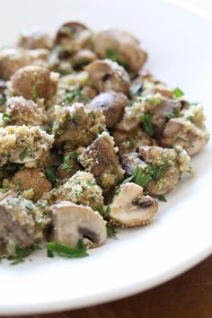 a white plate topped with mushrooms and parsley