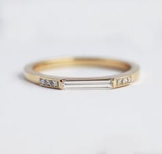 a gold ring with three diamonds on it