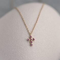 A dainty cross pendant with natural pink sapphire gemstones for women and girls. This small pendant is a great choice for a birthday gift for her. D E T A I L S ● Metal: 14K solid gold, 14K white gold  ● Gemstone: 16 Pink Sapphires, Round Cut, Natural ● Sapphires' Weight: 0.12 ct ● Length: 16 inches ● Cross dimensions: 13mm x 7mm H O W ∙ T O ∙ O R D E R Choose from the drop-down menu the available options (Metal) and leave us a note for any special requirements. G I F T S All our pieces are deli Jewelry Photography Tutorial, Dainty Cross Necklace, Small Crosses, Funky Jewelry, Jewelry Photography, Small Pendant, Natural Sapphire, Dream Jewelry, Sapphire Gemstone