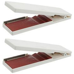 two red and white staplers sitting on top of each other