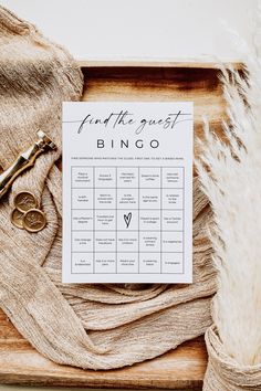 a wooden box with a sign that says, find the guest bingo